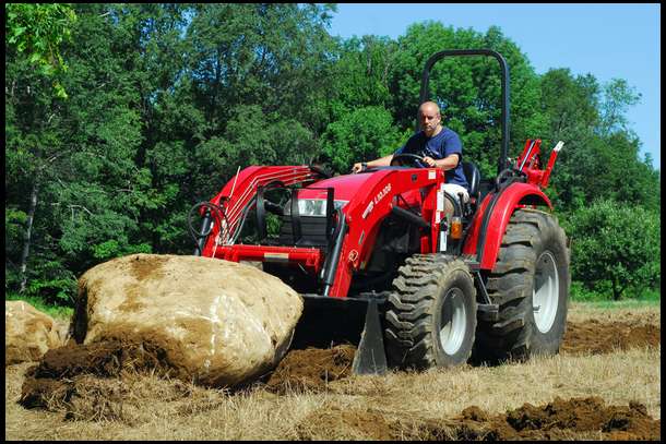 The first step was to pull rocks. We used our Tractor along with an 8' Woods Backhoe. This huge rock was pulled out after 2 hours of finessing it. Once out, we pushed it off the plot. All told, we pulled a dozen rocks ranging in sizes between a suitcase and this monster. Only one rock remained that was simply too large for our equipment.
